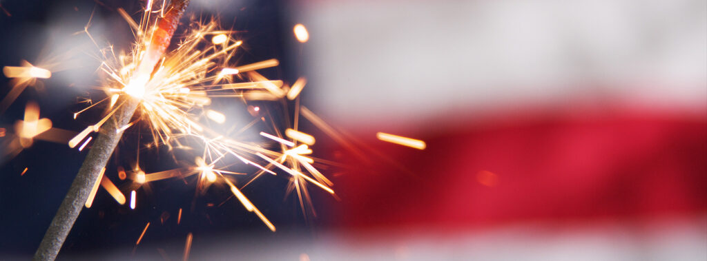 Fireworks in front of American flag