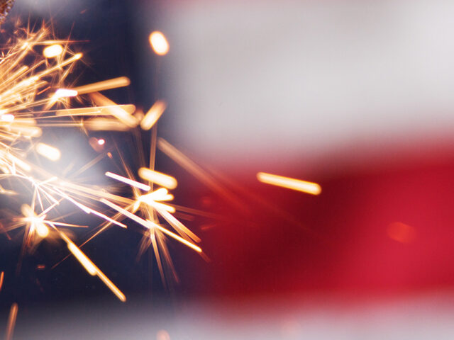 Fireworks in front of American flag