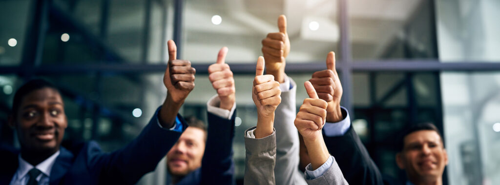 Men in suits giving thumbs up