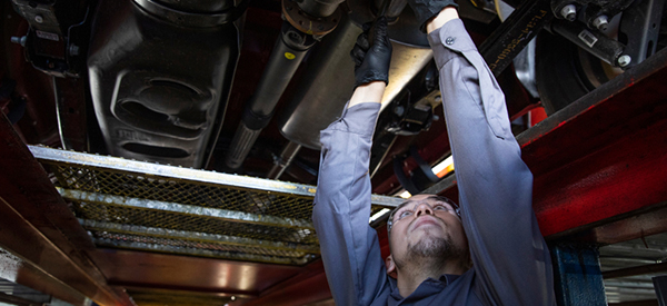 Automotive mechanic working on a car