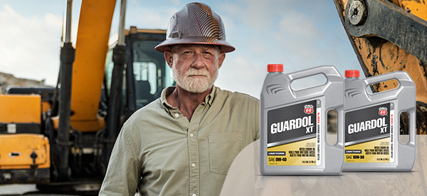 Construction worker standing next to construction equipment and Guardol