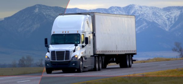 Truck driving in front of mountain range